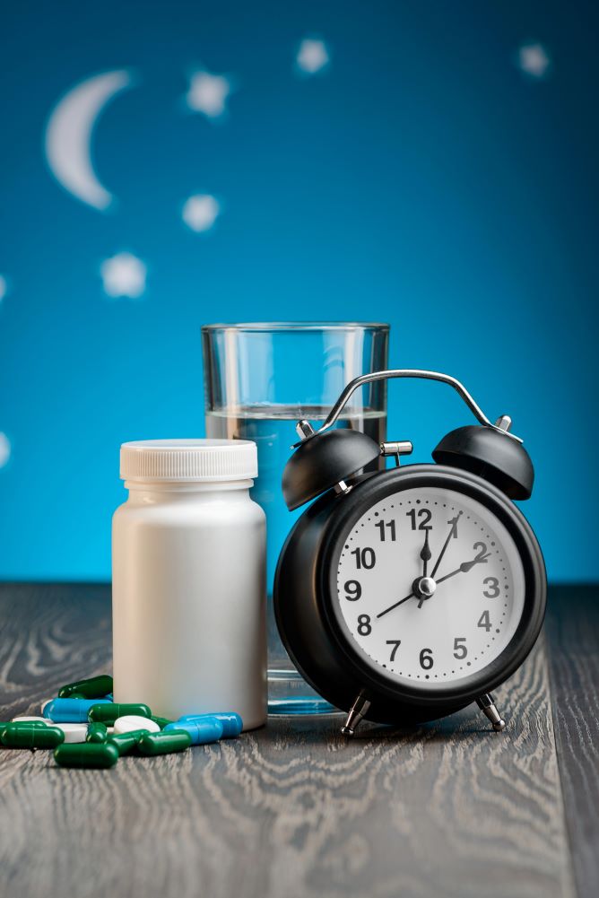 Pills, water and alarm clock