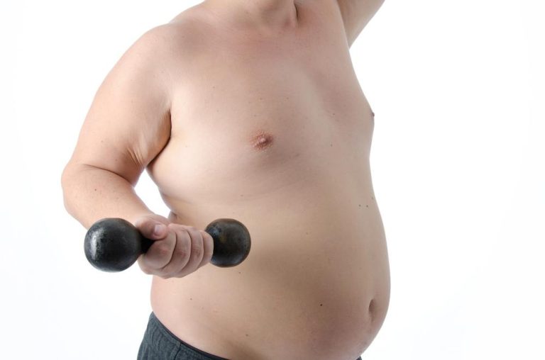 Fat unhealthy looking male body holding a small dumbell