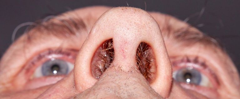 View up a human nose showing old age hairy nostrils close up