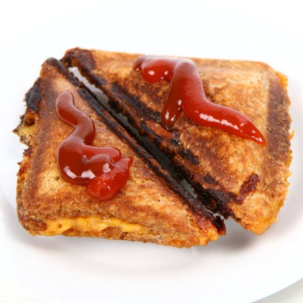 Burnt toasted sandwich with tomato sauce topping