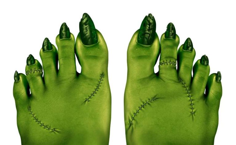 A pair of green feet with long pointy toe nails and stitches